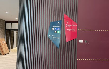 Indoor wayfinding signage for a public venue with modern design.