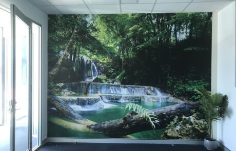 Large-scale nature-themed wall mural featuring a waterfall.