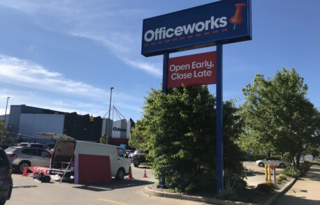 Tall Officeworks pylon sign featuring brand messaging.