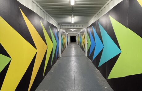 Colorful directional arrows on tunnel walls