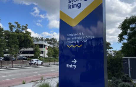Freestanding pylon sign for Storage King with directional entry guide.