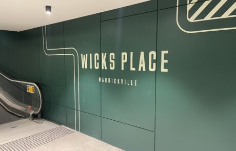 Large 'Wicks Place Marrickville' wall sign with modern typography.