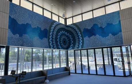 Large blue-themed indoor Custom wallpaper with intricate patterns in a modern building lobby.
