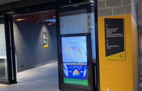 Digital advertising screen inside a shopping centre displaying a food promotion.