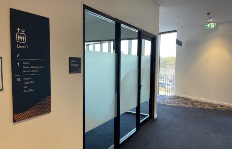 Level 1 directional signage for a venue, showing room and facility locations.