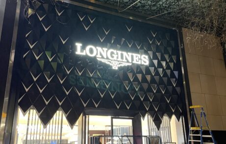 Longines store entrance with illuminated signage at night