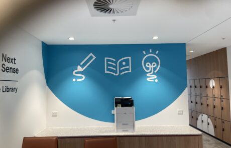 Interior wall mural with educational icons at Next Sense Library