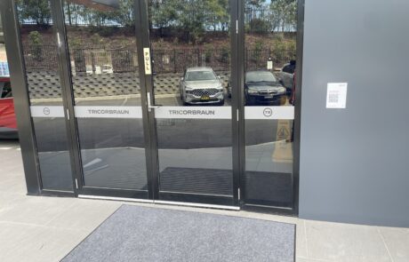 TricorBraun branded frosted glass window signage