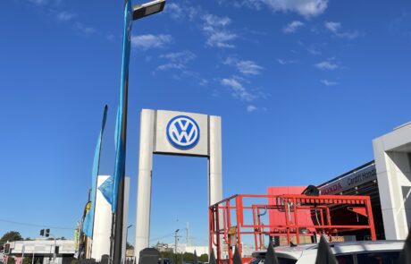 Volkswagen dealership pylon sign under a blue sky