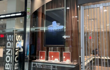 Jewelry store entrance with illuminated signage and modern design.