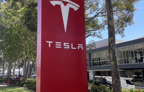 Large Tesla pylon sign with red branding