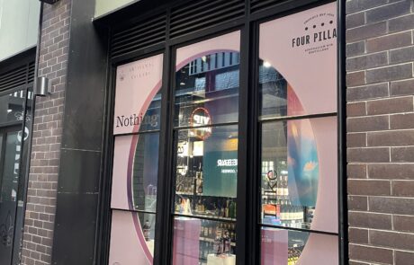 Four pillars window signage installation.