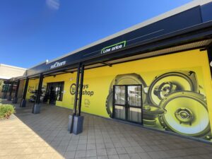Bold shopfront signage for Autobarn, featuring window graphics and fascia branding to enhance retail visibility.