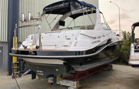 Fully restored Four Winns boat wrap in glossy black vinyl wrap, rear angle
